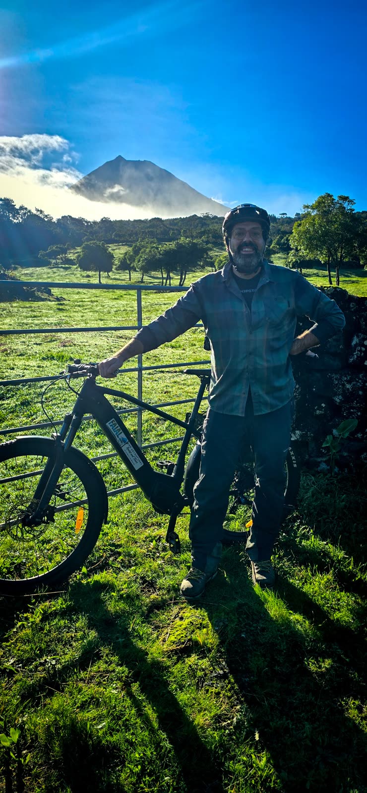 José with the BEEQ by a farm gate, with Pico mountain behind