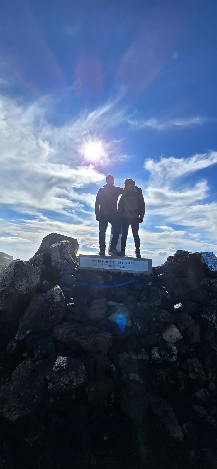 José and Cláudio at the summit marker, with the plaque Highest point in Portugal, altitude 2351 m